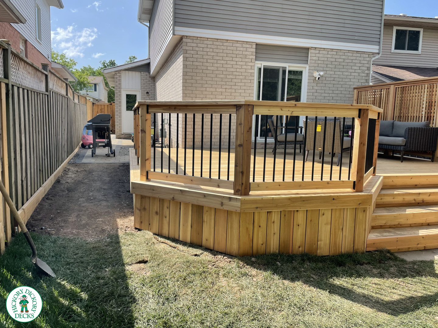 Cedar deck with four steps, cedar pickey railing, and a cedar privacy screen.
