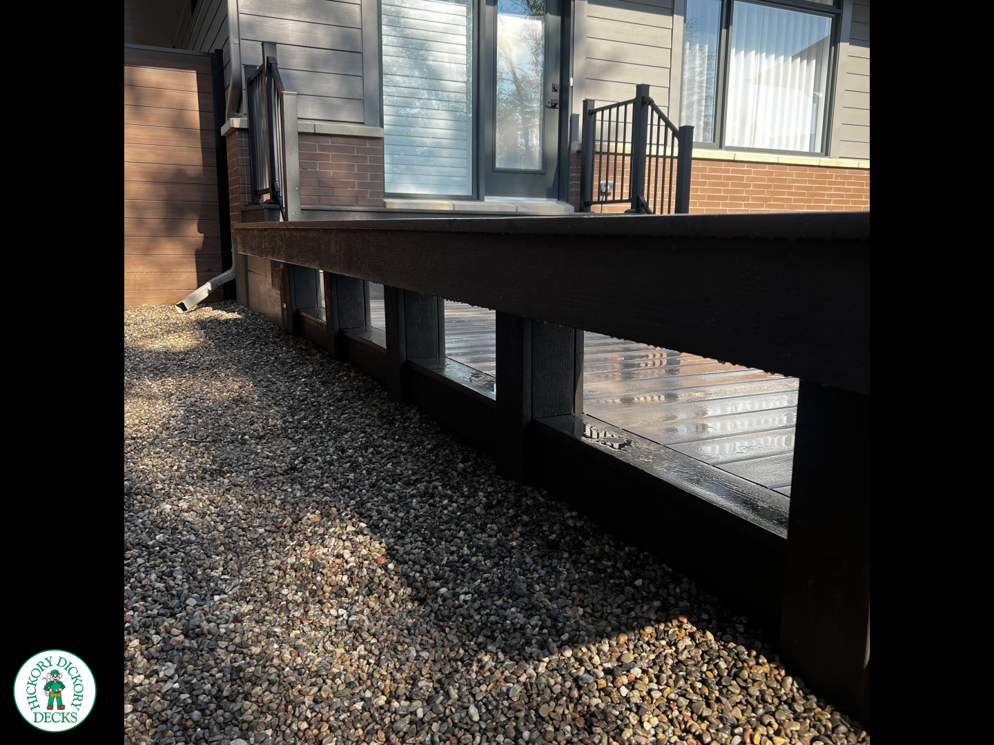 Grey Clubhouse deck with dark grey border, lighting in steps, and a custom bench.