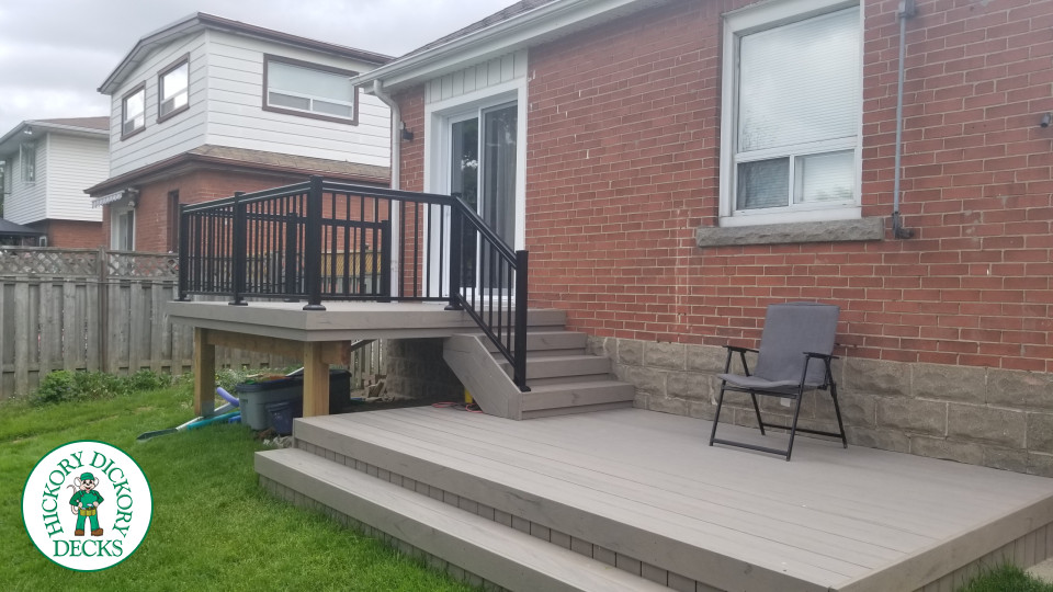 2 level Trunorth composite deck with steps to walk up deck, and wrap around stairs on the bottom level.