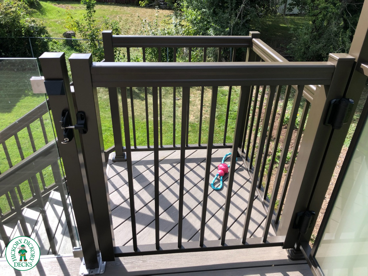 High grey composite deck with glass style railings.