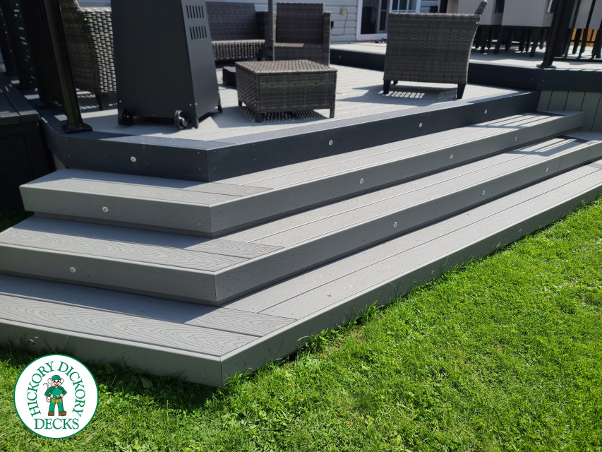 Trex deck in grey color with wrap around stairs, lights in steps.