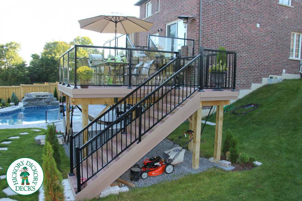 Trunorth high deck in light brown with glass railings.