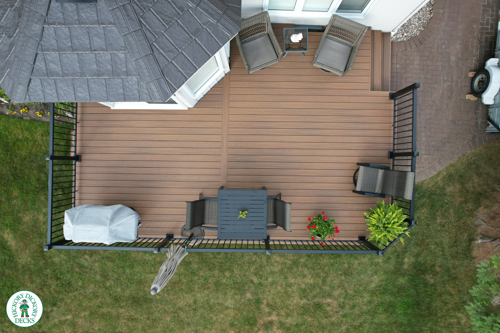 LArge brown fiberon deck with black aluminum railings.
