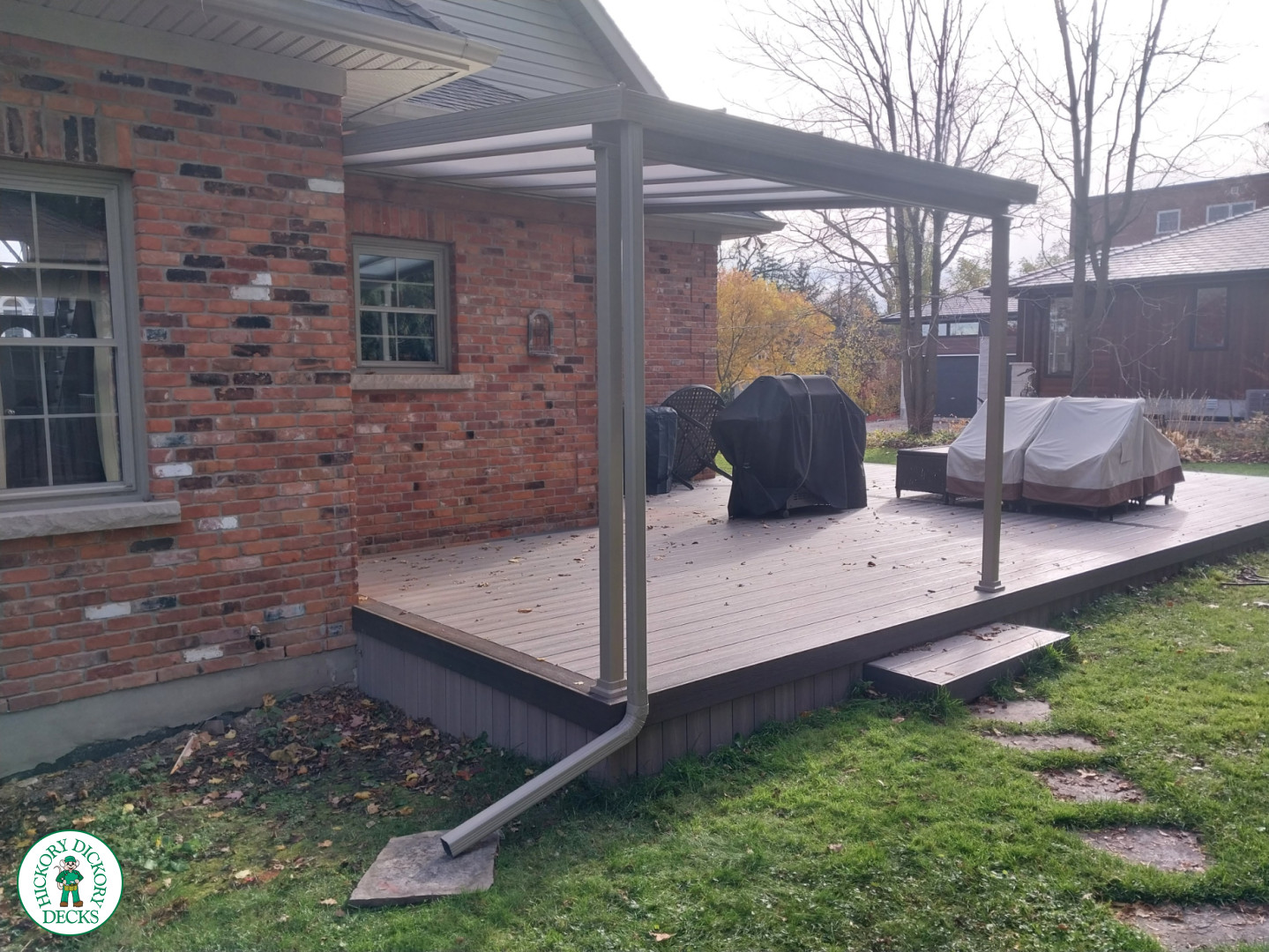 Grey deck with dark grey trim and a sunspace roof structure.